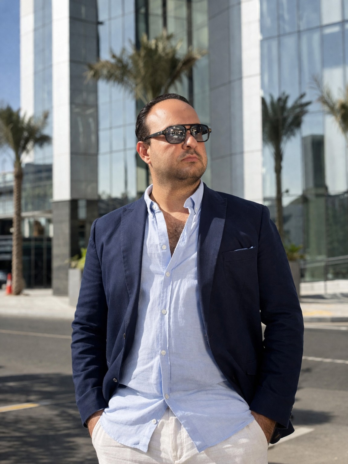 Marios Panikos Panayiotou — Certified Graphic Web Designer and Marketing Specialist, wearing a navy blazer and sunglasses